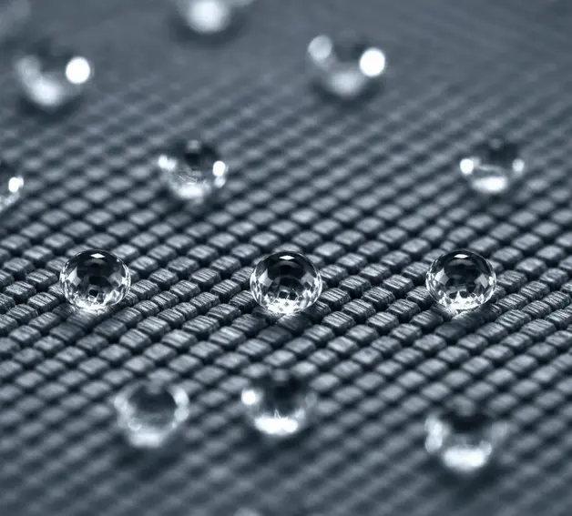 Nanostructured textile surface with microscopic fibres and water droplets showcasing advanced hydrophobic technology. - surface chemical modification of textile fibres 2