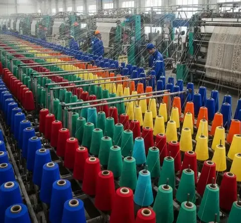 Colorful yarn spools displayed in a textile manufacturing unit symbolizing textile sizing and weaving preparation process. -Textile Sizing Chemicals. -1