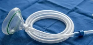 Transparent silicone medical tubing and mask on blue sterile background, soft lighting, highlighting flexibility and clarity. -Silicone for Medical Devices. -1