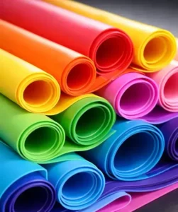 Close-up of colorful silicone rubber sheets rolled in layers, vibrant industrial materials, smooth texture, studio lighting, high detail. -Silicone Elastomer Manufacturers. -1