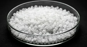 Macro view of white silicone rubber pellets in a clear petri dish on black background, industrial polymer granules, high contrast studio lighting. -Silicone Material Suppliers. -1