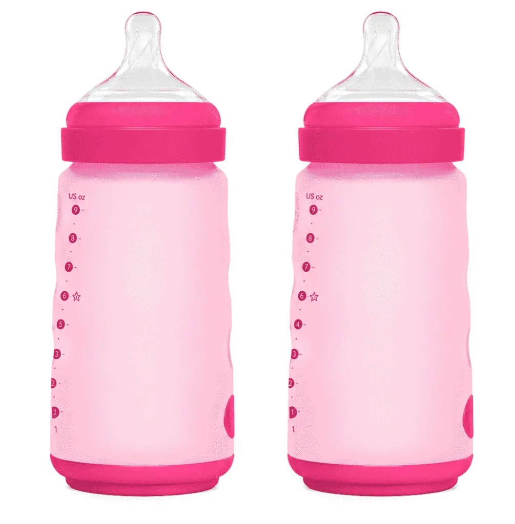 Two silicone baby bottles in baby pink and dark pink with clear nipples on a white background