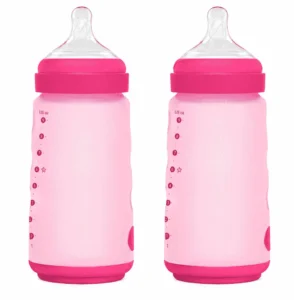 Two silicone baby bottles in baby pink and dark pink with clear nipples on a white background