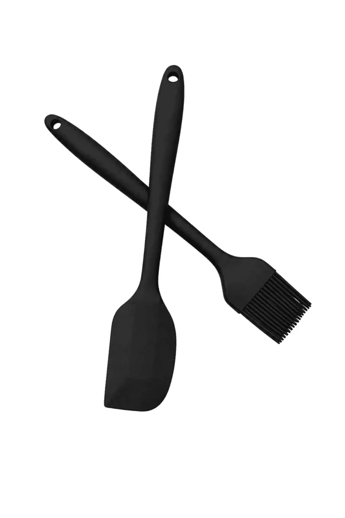 Black silicone spatula and silicone basting brush on a white background. silicone spatula
