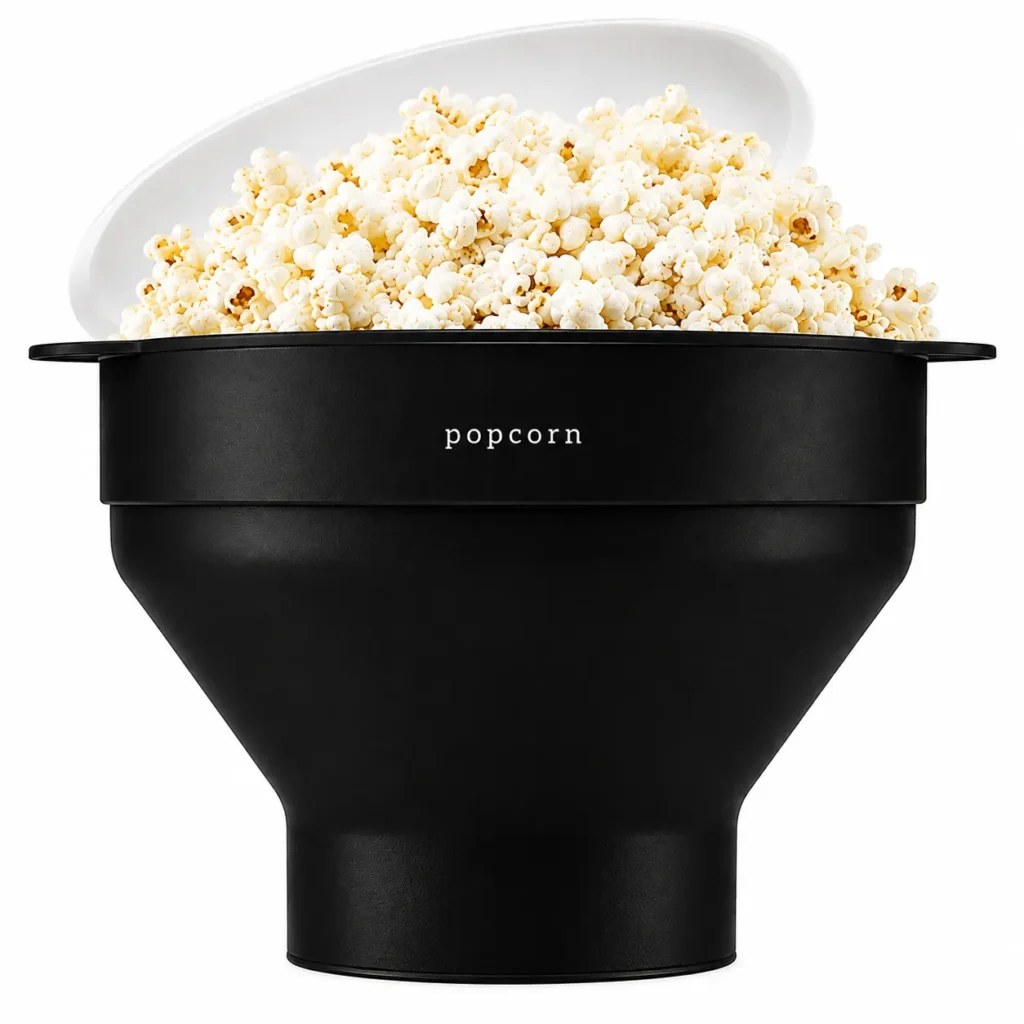 Black silicone popcorn popper filled with fresh popcorn on a white background