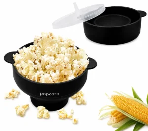 Popcorn in a black bowl with popcorn kernels and corn on the cob. - silicone popcorn popper 1