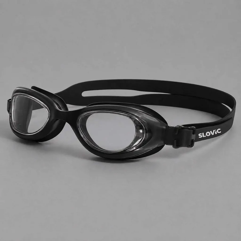 Black silicone swimming goggles with clear lenses on a grey background.