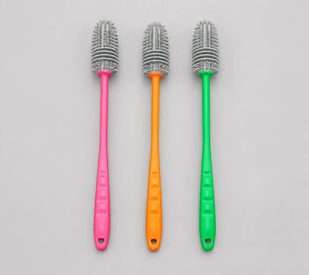 Pink, orange, and green silicone bottle brushes on a light grey background - silicone bottle brush -1