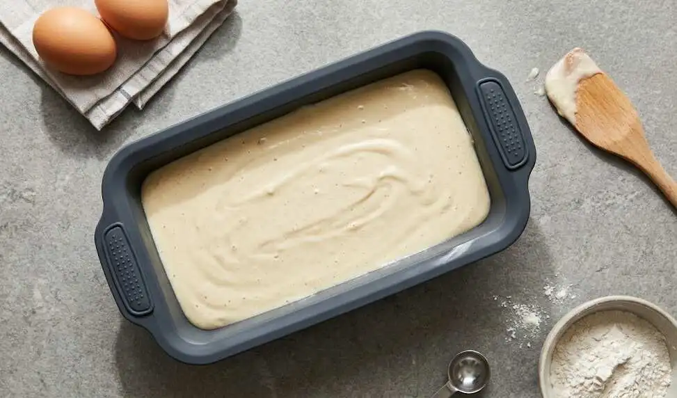 dark-grey bakeware filled with cake batter - Silicone loaf pan -2