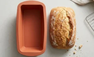 terracotta-orange bakeware next to freshly baked bread - Silicone loaf pan -1